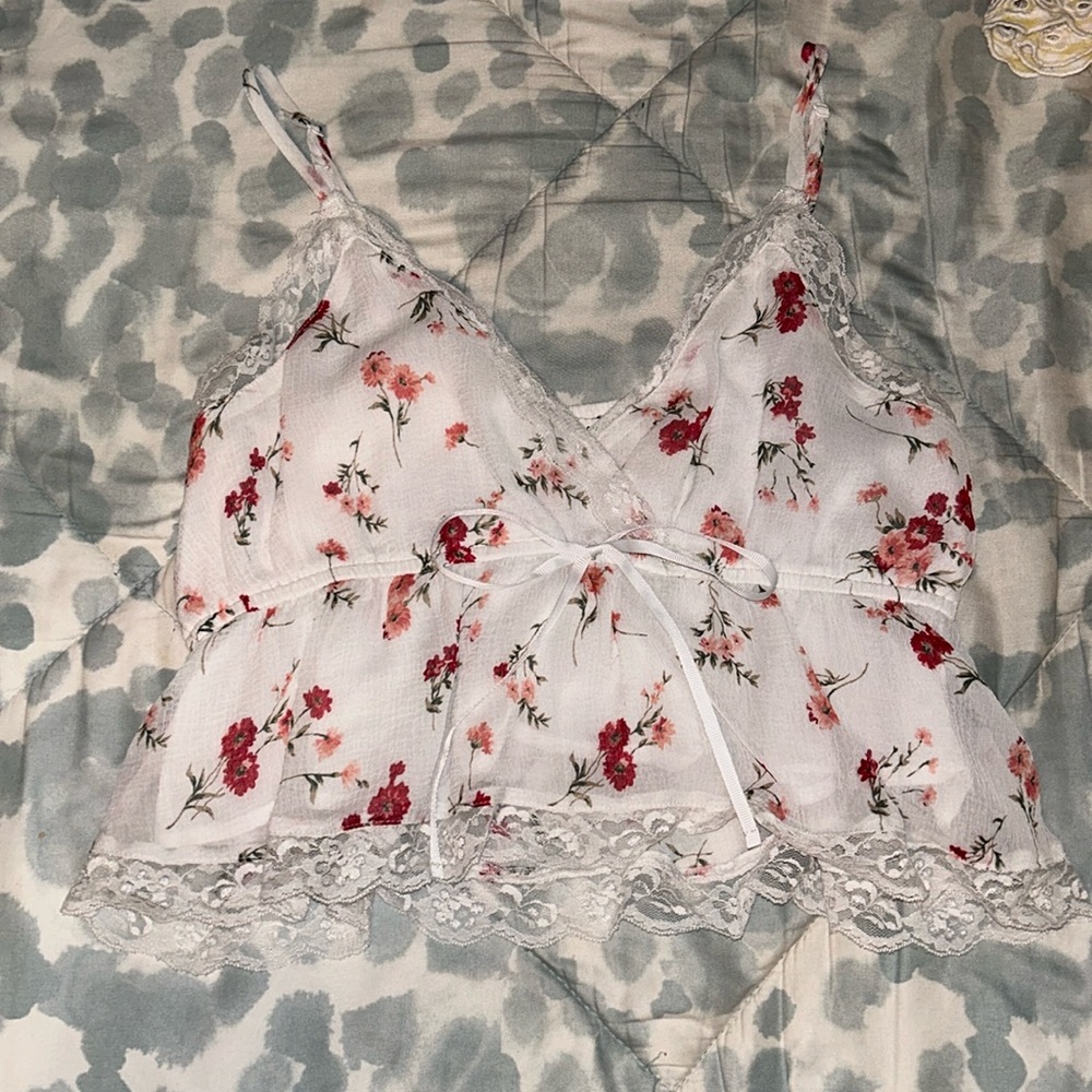 cute floral tank top with lace bottom and a bow tie under the chest area.